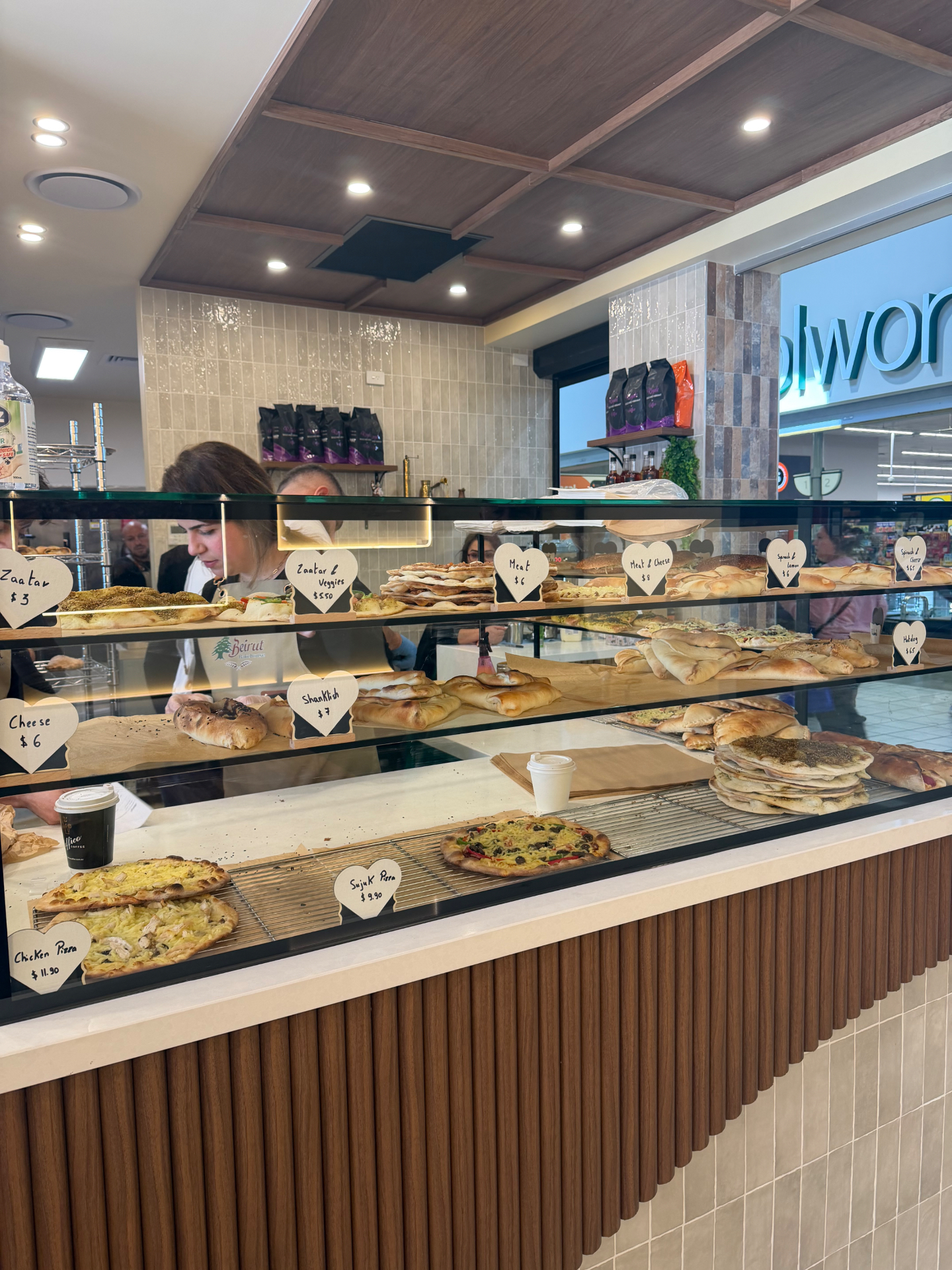 Display case filled with Lebanese flatbreads and baked goods at Beirut Bakehouse