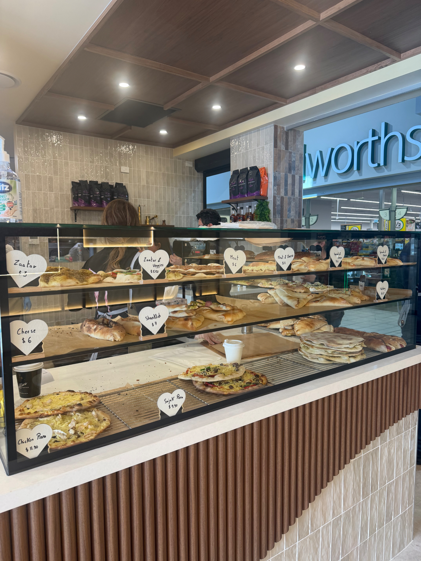 Fresh Lebanese pastries and flatbreads arranged in the Beirut Bakehouse display case